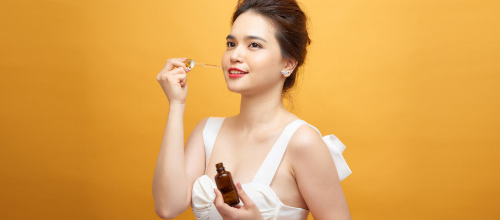 woman smiling while using beauty products
