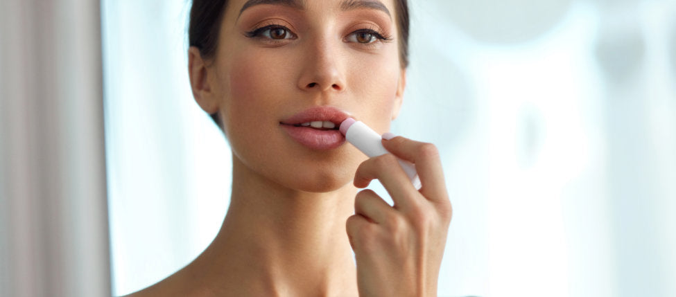 woman using lipstick